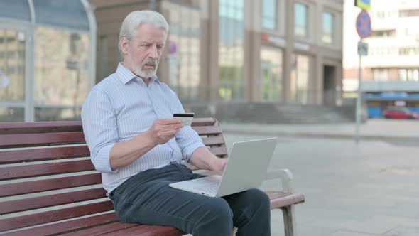 Old Man Having Online Payment Problem with Laptop Outdoor