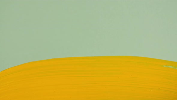 Abstract Brushstrokes of Yellow Paint Brush Applied Isolated on a Green Background