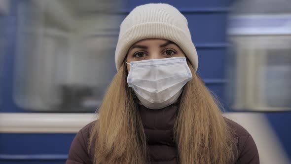 Woman In Virus Proof Mask On Face In Subway Against The Background Of Train