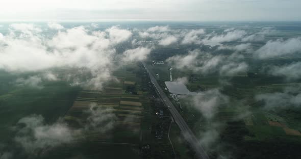 Through The Clouds Opens A Beautiful Landscape Of Fields And Roads With Transport