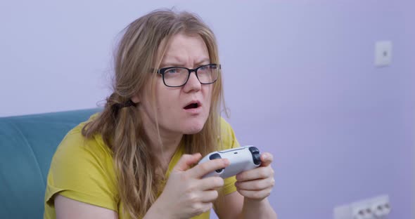 Focused Sloppy Woman Plays Game Console Refusing to Distract