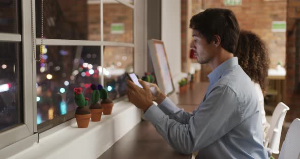 Creative businessman using digital table in modern office