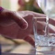 Man pouring water from a clear jug into a waterglass. - VideoHive Item for Sale