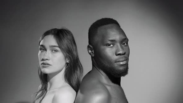Portrait of Shirtless Diverse Couple Standing Back to Back