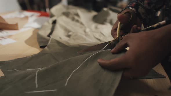 Dressmaker Cutting out Fabric after Transferring Paper Pattern