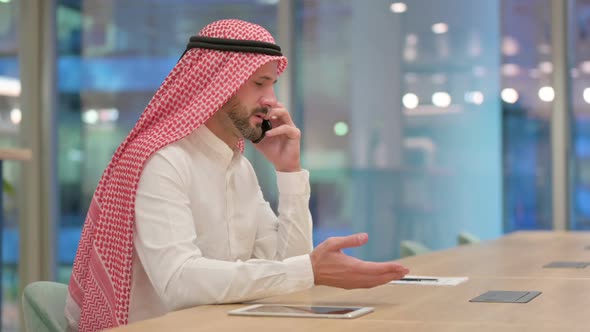 Arab Businessman Celebrating Success on Smartphone