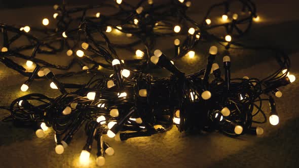 Closeup Shot Hank of Christmas Garland with Golden Lights on a Playd