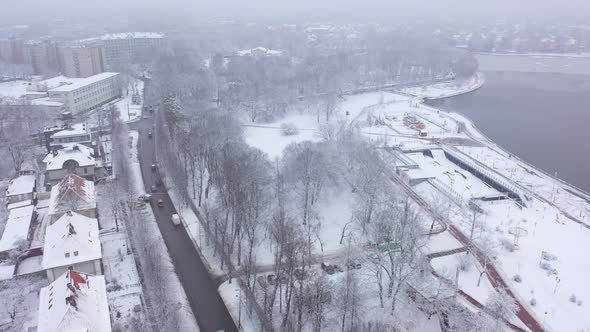 Aerial: Traffic along the coast of Upper Lake in the wintertime