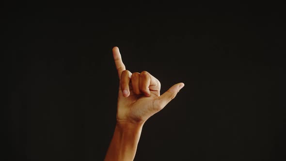 African American Man Showing Hawaiian Shaka Greeting Gesture with Fingers Isolated on Black