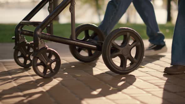 Parent Legs Carriage Wheels Rolling Walkway Closeup