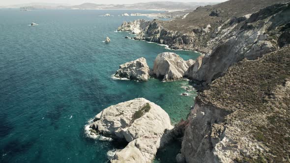 Slowly moving past a rocky cliffside overlooking the breathtaking turquoise blue water of the Medite