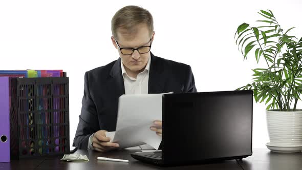 Businessman Working in Office. Making Report Analysis Reading Papers at Table