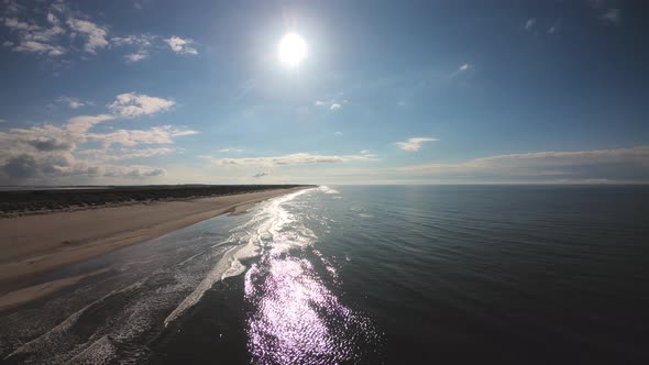 Aerial, drone shot flying slowly over a beach