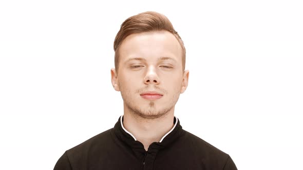 Young Handsome Man Listening Attentively Smiling Over White Background