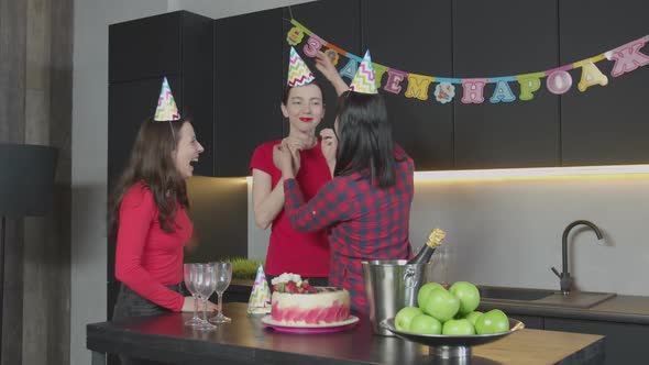 Caring Mom Bettering Hats To Daughters at Birthday