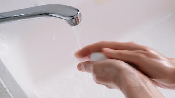 Woman Washes Hands with Soap