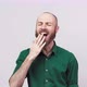 Portrait of a sleepy man yawning or feeling boredom isolated over white background. - VideoHive Item for Sale