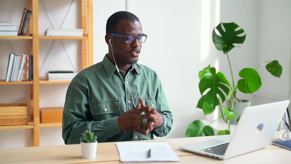 Millennial Businessman Discussing Startup During Online Conference at Table with Laptop Spbas