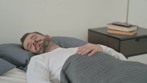 Man Waking Up From Nightmare in Bed