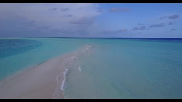 Aerial top down panorama of tranquil coastline beach adventure by blue lagoon and white sand backgro