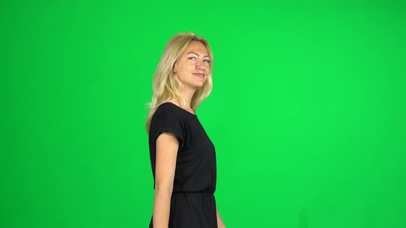 Woman Walks Calmly Down the Street, She Is Happy. Green Screen. Side View