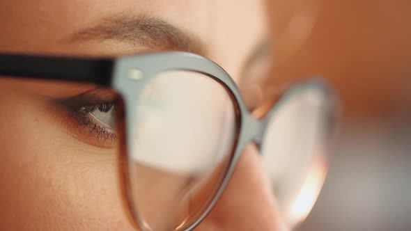 Reflection on the glasses of the woman searching stock conten.