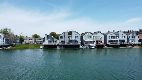 Rising Slider Shot Of Fabulous House Cottages On Blue Lagoon, Parkside Aquatic Park, San Mateo