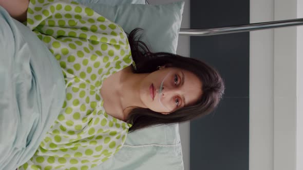 Vertical Video Portrait of Sick Woman Wearing Nasal Oxygen Tube Resting in Bed