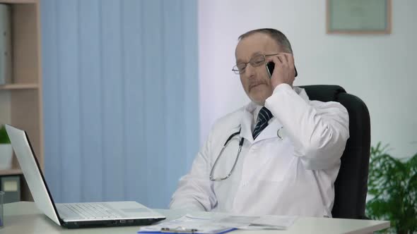 Experienced Physician Discussing His Treatment Methods and Approaches by Phone