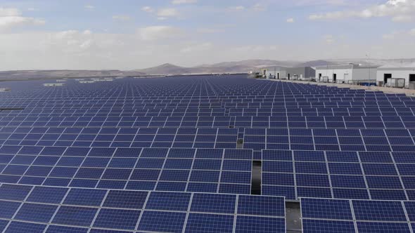 Aerial Shot of a Huge Solar Power Plant in a Big Field. Electricity Generation From Solar Energy alt