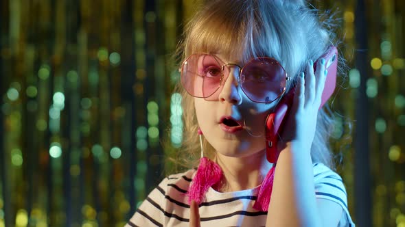 Girl in Futuristic Glasses Talking on Mobile Phone with Friend in Night Club with Neon Blue Light