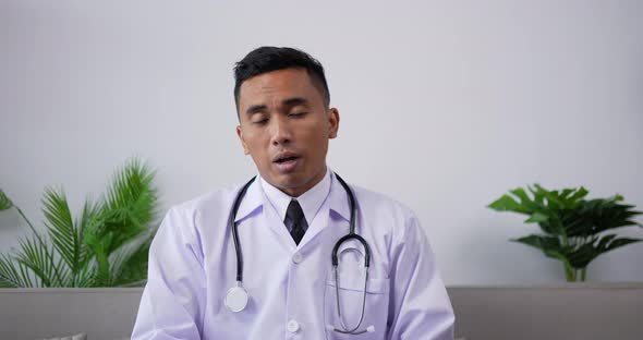 Doctor talking to patient making video call and looking at camera