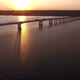 Aerial Shot of a Beautiful River Bridge Over the Dnipro with a Golden Sun Path - VideoHive Item for Sale