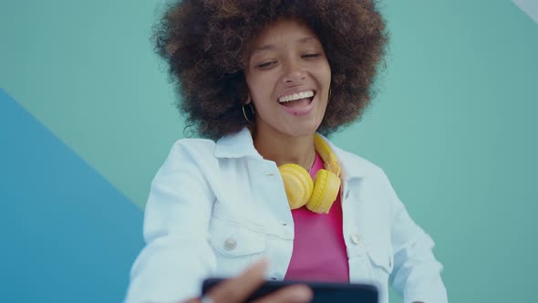 Beautiful young woman with curly hairstyle and fashionable clothes