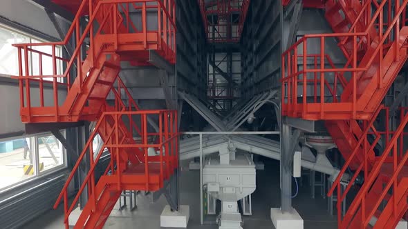 Indoor orange ladders on a wheat mill. Aerial view 03