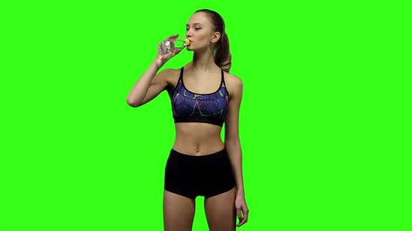 Girl in Sportswear Drinking Water From Bottle. Slow Motion. Green Screen