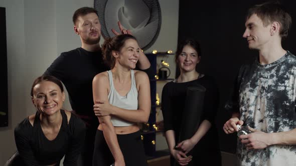 Group of Sportsmen Fooling Around in Front of the Camera Inside the Studio