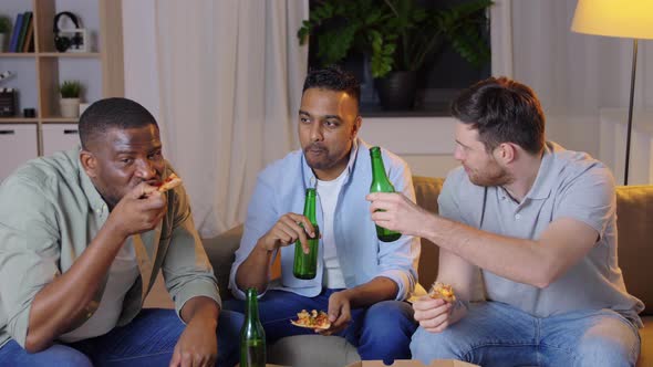 Happy Male Friends with Beer Eating Pizza at Home