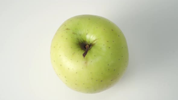 Ripe green apple on a white background close-up. 