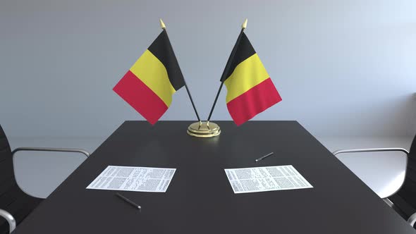 Flags of Belgium and Papers on the Table