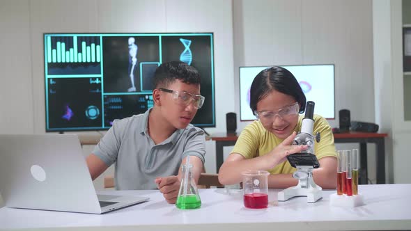 Young Asian Boy And Girl Learning Science Experiment. Study With Scientific Equipment