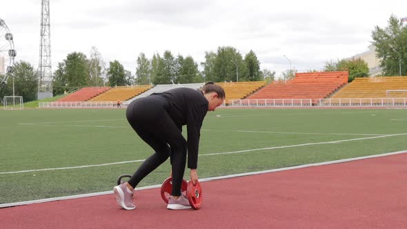 Graceful Slim Woman Warming Up at City Stadium