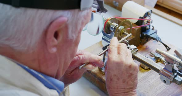 Horologist repairing a watch