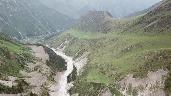 The River Runs Through a Green Gorge in Mountains
