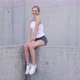 Cheerful Sportswoman Sitting on Concrete Wall - VideoHive Item for Sale