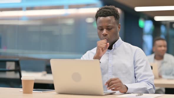 African Businessman with Laptop Having Coughing