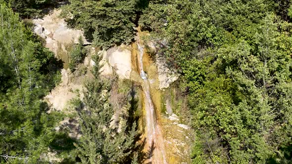 A small waterfall in the mountains aerial view 4 K