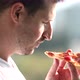 Handsome man eating pizza outdoor. - VideoHive Item for Sale