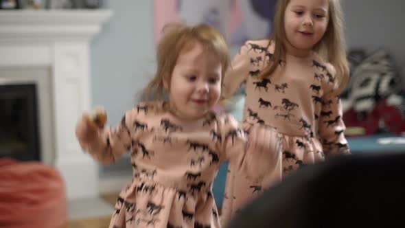 Picture of Beautiful Two Little Children Wearing Dresses Having Fun and Playing Around While Resting