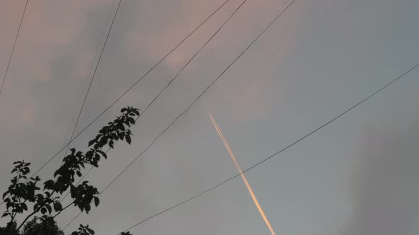 Plane with white trail in the sky
